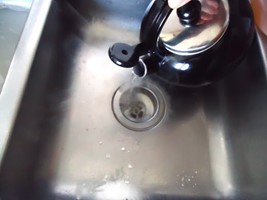 boiling water being used to fix kitchen sink smells