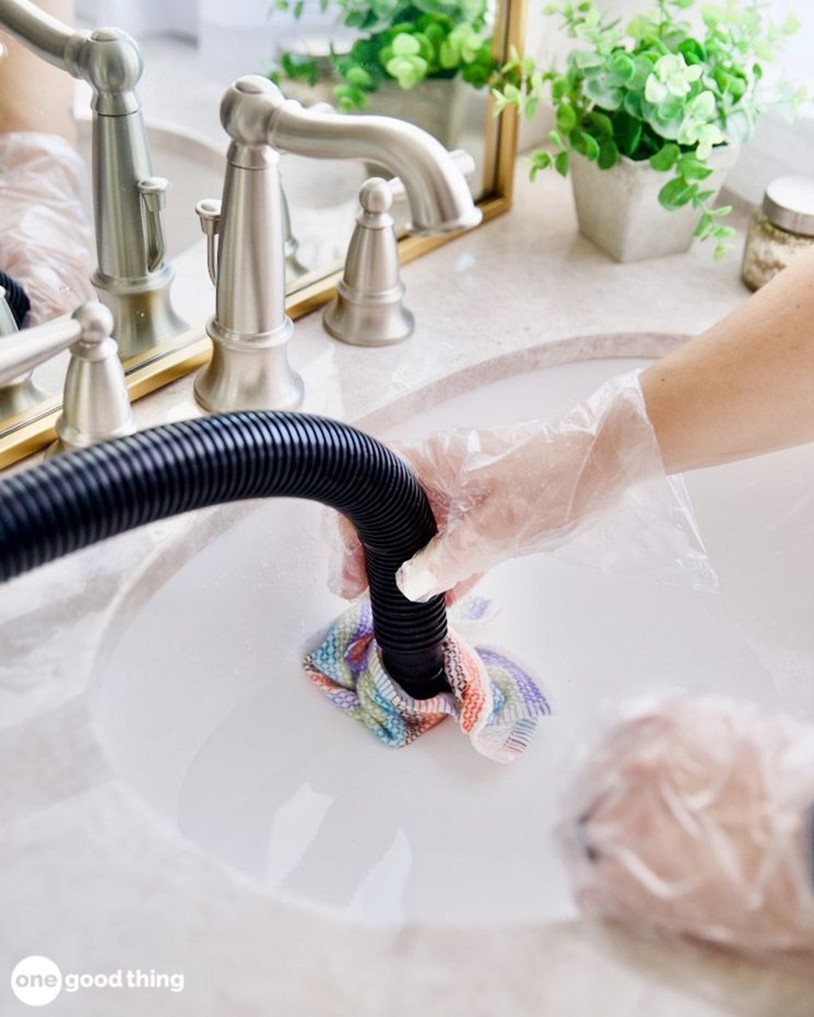 unclogging a sink drain in a bathroom with a wet-dry vacuum