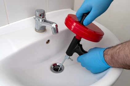 unclogging a sink with a snake